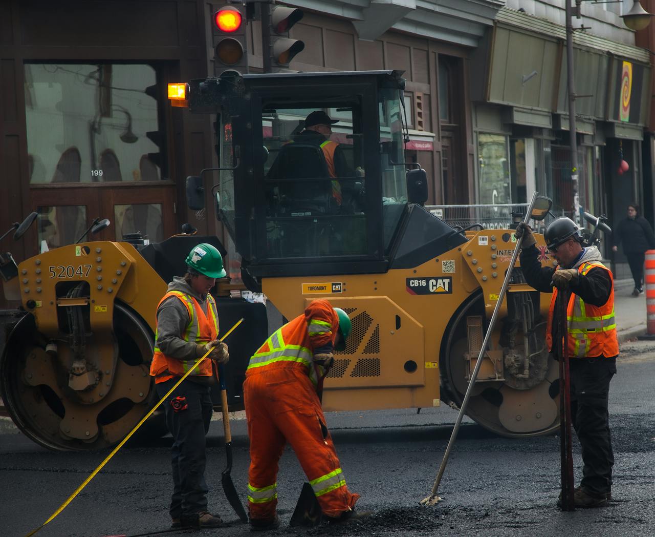 services-03 Workers and machinery paving a road in urban Québec City, Canada.